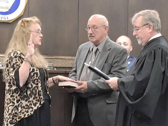 Councilwoman Sandra Lee Diglio takes the oath for her fourth term as Vincent Perrotto holds the Bible.