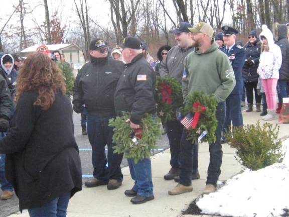 Past and present members of the armed forces wait to present wreaths Saturday in Sparta.