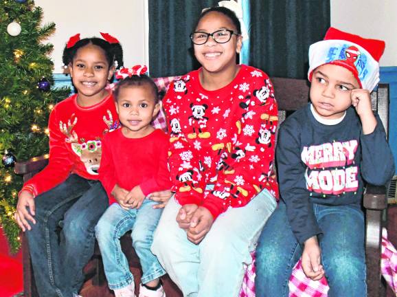 Dagleny, Dalia and Daniela Montero are shown with Dean Holland. They are all from Newton.