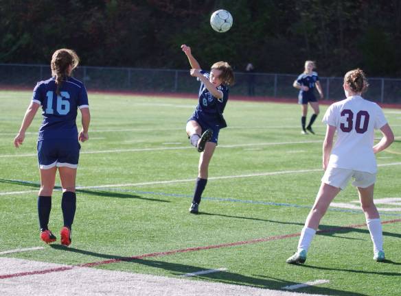 Sparta's Hailey Mead in the midst of kicking the ball.