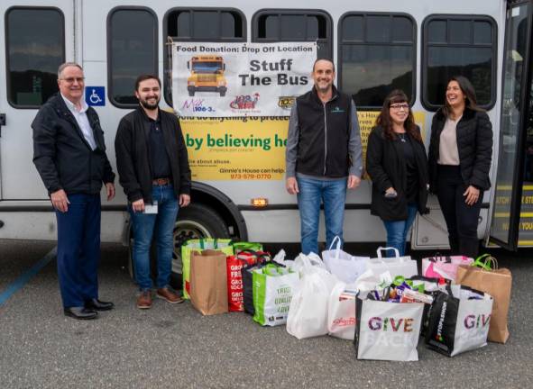 From left, Keith Niedorgail, Michael Bostedo, Ron Feldman, Julie Perrone and Stacy Moore drop off donations for the annual Stuff the Bus campaign against hunger.