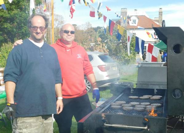 Byram Mayor Alex Rubenstein (L) and youth football coach Ken Goss (R) serve of burgers to participants in the Byram Charity Hike at Hudson Farm on Saturday, Oct 12, 2019.