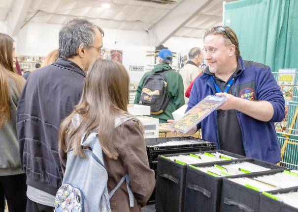 Dave O'Hare, founder of Garden State Comic Fest, shows a comic book to visitors.
