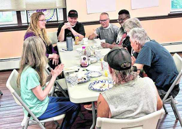 The Reverend Chris Streeter and the Reverend Patricia Lyons converse with Emily Jerger, Project Self-Sufficiency, and attendees at the New Beginnings Community Breakfast at Christ Church Newton.