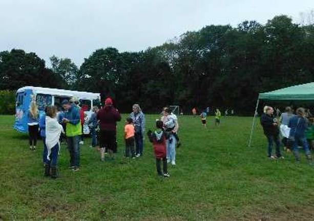 Parents and students wait in line for ice cream and face painting
