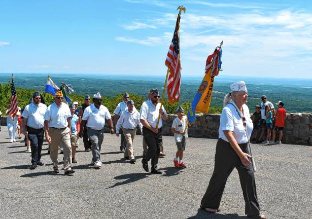 <b>Veterans march up to the New Jersey Veterans Memorial for the annual service.</b>