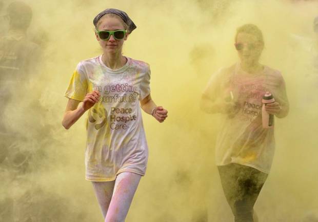 Packets of different colors are thrown on the participants in a Color Run.