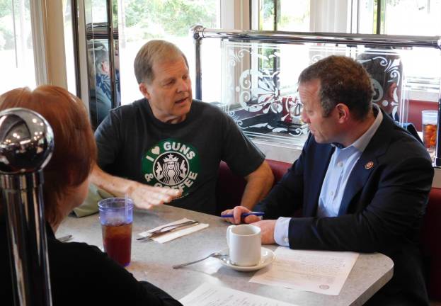 Green resident John Wrobleski (L) speaks with Rep. Josh Gottheimer (D-NJ5, at R) during a Cup of Joe with Josh event at the Rt. 206 Diner in Andover Borough on Tuesday, Oct 8, 2019. Also seated is Noreen Anne Walsh of Andover Borough.