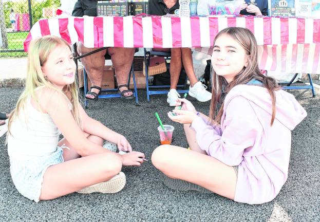 Dianna and Annalise Zito of Newton paint rocks.