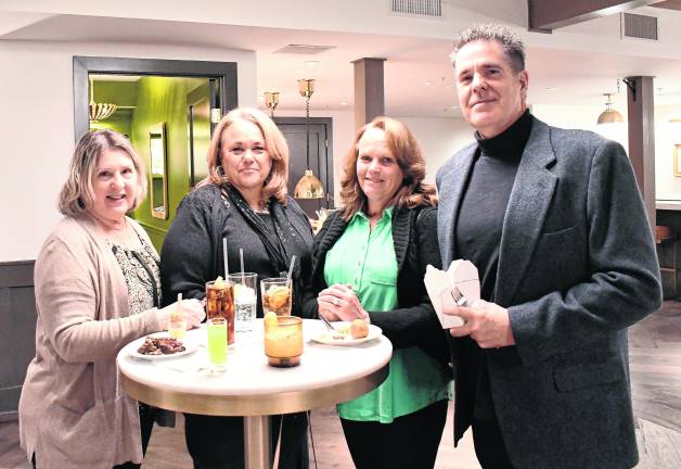 <b>Dawn Niper, Karen Kymer, Audra Preste and John Preste all from Kymer's Camping Resort, stand around a table.</b>