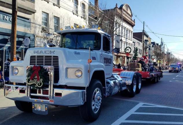 Terco Construction’s Mack flatbed hauls a Christmas scene during the Annual Holiday Parade in Newton on Saturday, Nov 30. 2019.