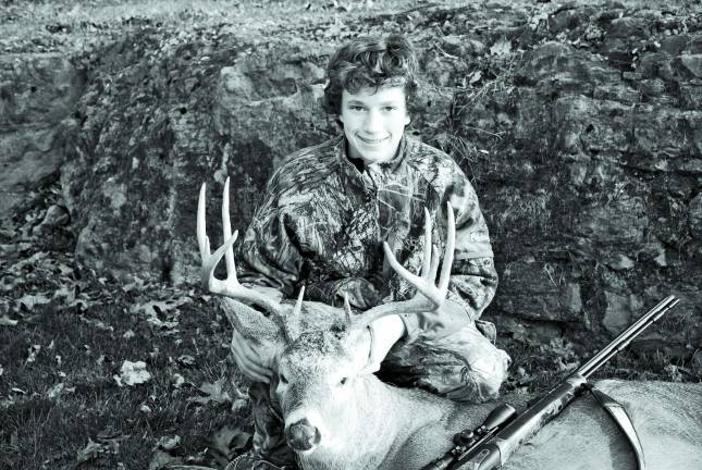 Garrett Kazar with a 10-point buck he shot.