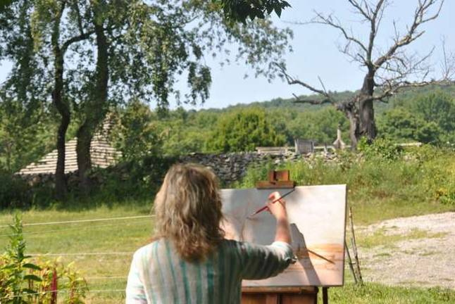 Lisa Hannick who's a professional artist is painting a dead tree seen from the hollow below the main center. It's in stark contrast to the other trees and flowers in full bloom all around — although the artist could not say why she had chosen that particular spot.
