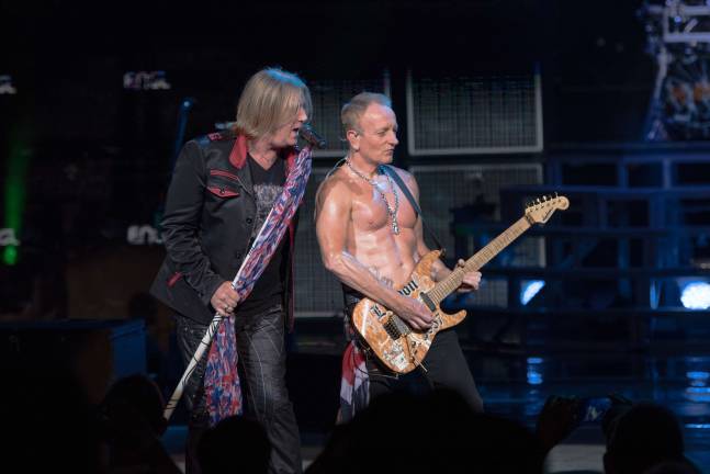 Def Leppard singer Joe Elliott (left) and guitarist Phil Collen (right) play a song during Saturday's set at Bethel Woods Center for the Arts. Photo courtesy of Bethel Woods.