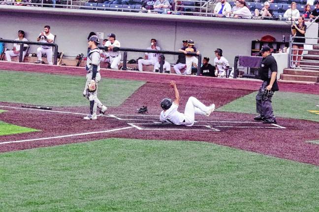 <b>In the fifth inning of the Sussex County Miners’ game against the Québec Capitales on June 13, Dom Johnson of the Miners slides safe across home plate to increase his team’s lead to 3-0. The Miners won, 6-0. (Photos by George Leroy Hunter)</b>