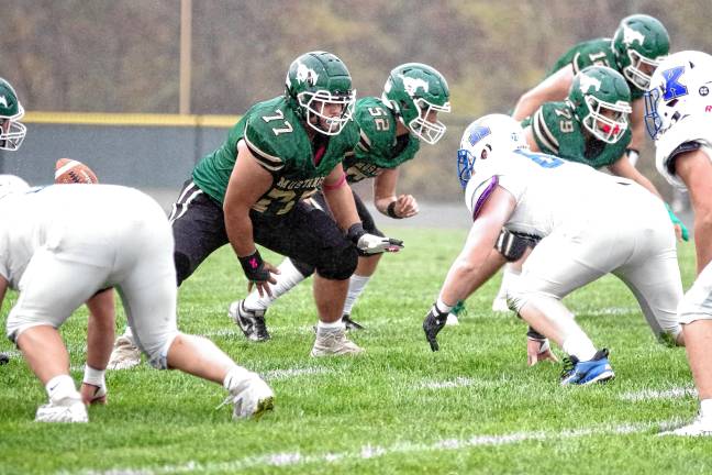 <b>After snapping the ball, Sussex Tech offensive lineman Marco Castro (77) rises to defend.</b>