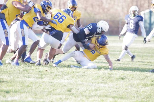 Monroe College quarterback Mason Boothe is taken to the ground by an SCCC defender in the second half.