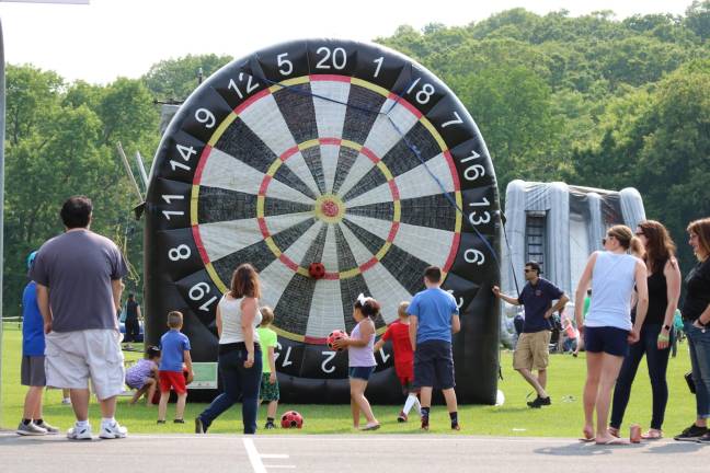 Children were excited to play with a giant velcro dartboard and a sticky ball. (Photos by Shannon Kuratli)