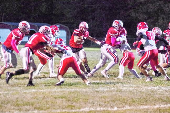 <b>High Point quarterback Jerron Martress carries the ball through an opening in the Lenape Valley defensive line. He rushed for 189 yards and made three touchdowns.</b>