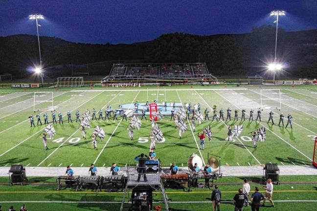 <b>The Sparta High School Marching Band and Color Guard perform during halftime.</b>