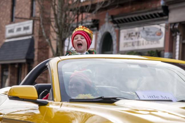 Little Mister Newton Roger McKelvie shows his excitement as he rides in a car during the parade.