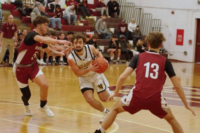 West Milford's Dean Deaver maneuvers the ball between two Newton defenders. He scored 16 points.