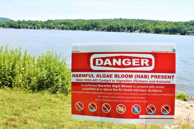 Photo by Garrett Hemmerich A lakeside sign at Brown's Point Park in New Jersey warning of danger of harmful algae bloom was put up by the state Tuesday morning.