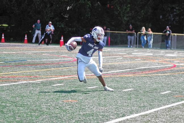 <b>Pope John kick returner Zayne Carswell is on the move in the second quarter. (Photo by George Leroy Hunter)</b>