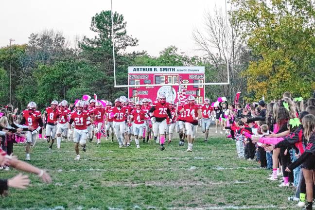 <b>The High Point Wildcats charge onto the field before the start of the game. Their record is 6-1.</b>
