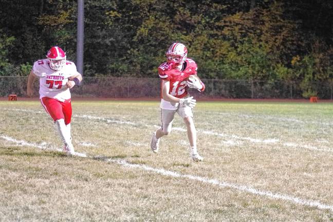 <b>High Point ball carrier Slade Muller is chased by Lenape Valley defensive lineman Will Doyle in the first half.</b>