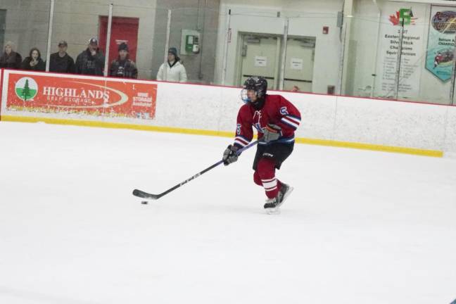 A Newton/Lenape Valley player controls the puck.