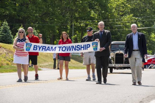 The Byram Memorial Day Parade gets under way. Tom Kirk, in dark blue shirt at center, was the featured speaker at a ceremony before the parade.