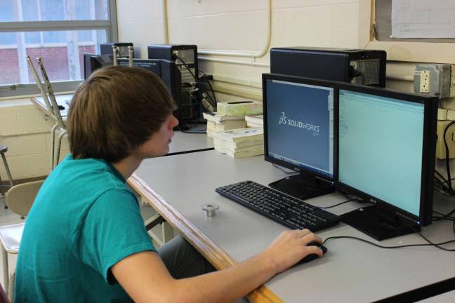 Team co-captain and build team leader, Jake Kolzow, creating this season's robot on CADD.