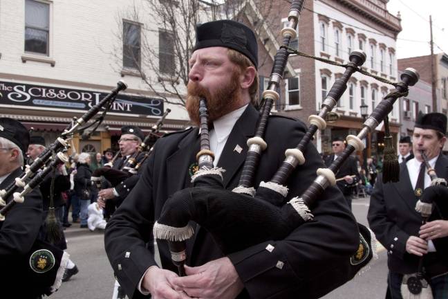 A member of the Rory O'Moore School of Piping &amp; Drumming plays the bagpipes.