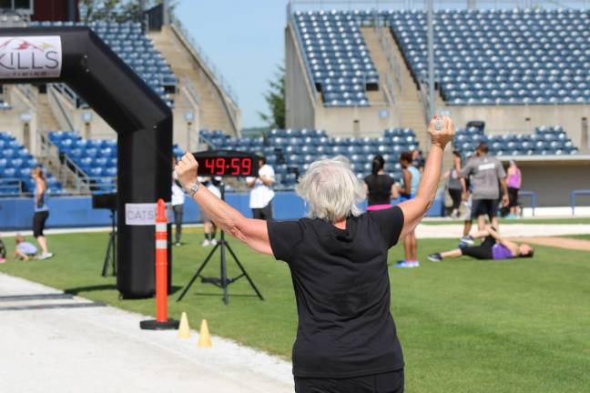 63-year-old Kathy Banach of Unionville, NY is euphoric as she nears the finish line of her very first 5K race. &quot;I made it in under an hour,&quot; and there are people behind me that are half my age!&quot; she said. (Photos by Shannon Kuratli)
