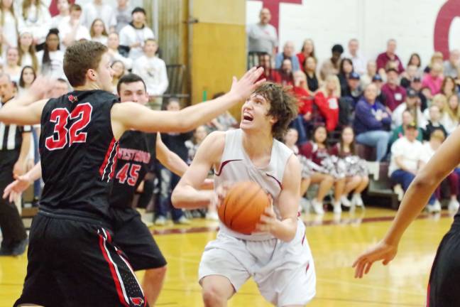 Newton's Charlie Maker focuses on the basket while covered. Maker scored fourteen points.