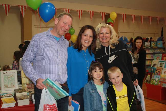 Hilltop families enjoy the book fair: Ken and Dawn Salmon with daughter Lucia; Claudia Dorman with son Hunter Dorman.