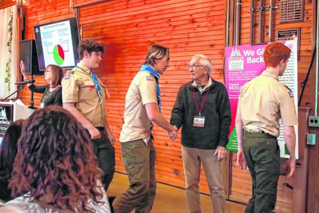 Boy Scouts shake hands with Dan Sarnowski, a board member of the German Christmas Market. (Photo by Brielle Kehl)