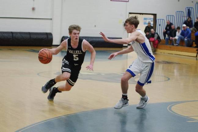 Wallkill Valley's Shawn Falk dribbles the ball while Kittatinny's Brian Plath tries to keep pace in the second half. Falk scored 11 points.