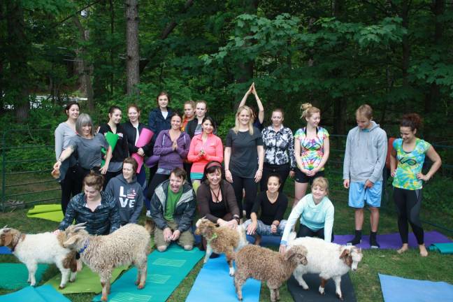 Participating yoga students, Yoga Youniverse teachers and goats pose for a photo opportunity last Saturday morning at Sparta Farmers Market.&#xa0;