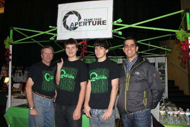Coach Jim Hofmann, team member Cameron Matulewsk, team member David Nelson and Green Township Superintendent John Nittolo
