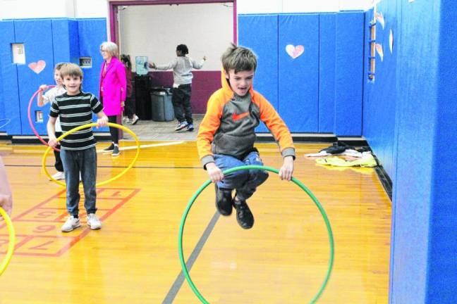 Students exercise with hula hoops as part of the Kids Heart Challenge fundraiser.