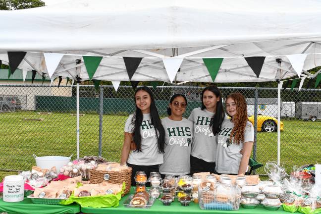 Hopatcong High School cheerleaders Camila Milan, JaLynn Ortiz, Olivia Buckley and Sophia Viglioti sell cookies at the festival, which includes a retail vendor market, food trucks, a car show and children’s activities.