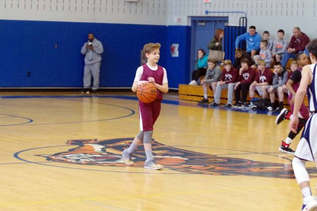 Newton's Robert Giordano handles the ball at midcourt.