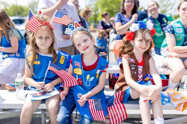 Young Girl Scouts hold flags at the Memorial Day ceremony in Newton.