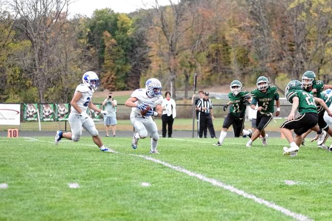 <b>Kittatinny's Niko Martinez carries the ball as several Sussex Tech defenders close in. He made a touchdown in the second quarter.</b>