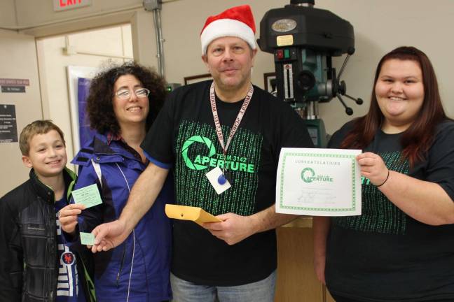 Matthew Guziewicz, Raffle Ticket Winner Mrs. Angela Guziewicz, Mr. James Hofmann (coach), and Lara Pennell (team captain).