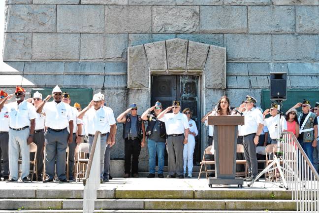 <b>Veterans salute as Mariana Segura sings the National Anthem.</b>