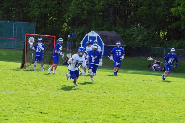 Players from both teams in hot pursuit of the ball.