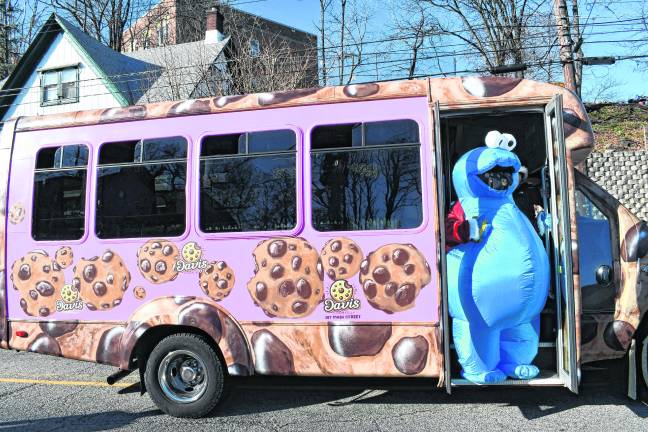 Cookie Monster peers out of a Davis Cookies vehicle at the parade.
